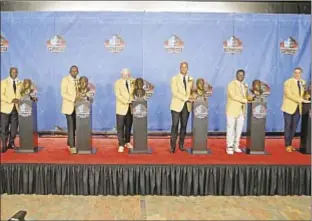  ??  ?? New members of Football Hall of Fame — Terrell Davis (from l.), Kenny Easley, Jerry Jones, Jason Taylor, LaDainian Tomlinson and Kurt Warner — pose with busts.