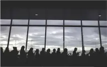  ??  ?? FILIPINA WORKERS returning home from Kuwait arrive at the Manila internatio­nal airport on Feb. 18. After a horrific murder of a Philippine maid in Kuwait, who comes from a small town in Iloilo, hundreds of such women are now streaming back home,...