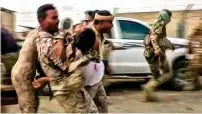  ?? AFP ?? COWARDLY ACT: In this video grab, a wounded Yemeni soldier is carried by troopers after a drone exploded above Al Anad airbase in the government-held Lahj province on Thursday. —