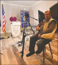  ?? Submitted photo ?? READY TO ROLL: Rotarian Larry Wilson, seated, right, prepares to video club President John Weidert at podium.
