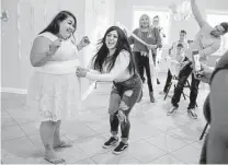  ?? ?? Maria Hernandez, left, playing a baby shower game with Eliza Mendoza, lives close to Texas Vista Medical Center.