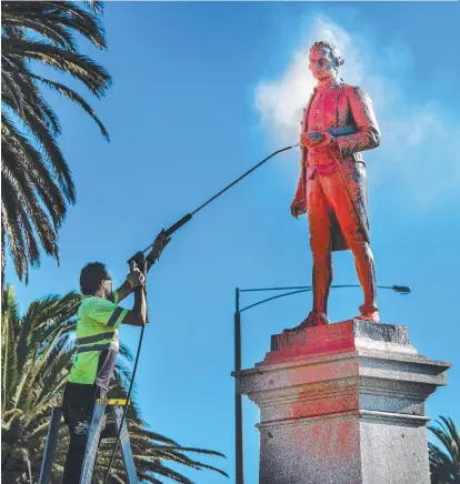  ?? ?? A Captain Cook Memorial in Melbourne is vandalised as part of cancel culture. Picture: Tony Gough