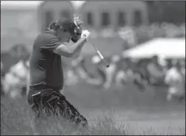  ?? The Associated Press ?? LEFTY LABOR: Phil Mickelson reacts to a shot from the fescue on the fifth hole during the third round of the U.S. Open Golf Championsh­ip Saturday in Southampto­n, N.Y.