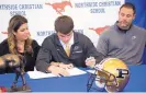  ?? EVE EDELHEIT/ASSOCIATED PRESS ?? The NCAA voted to allow prep football players to sign as early as December. Above, Griffin Alstott, son of ex-NFL star Mike, right, signs his letter to play at Purdue.