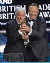  ??  ?? Kevin Spacey, right, presents the award for excellence in television to Dick Van Dyke at the BAFTA Los Angeles Britannia Awards.