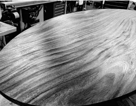  ?? PHOTO CREDIT: STEVE MAXWELL ?? This acacia wood table top is being refinished with oil. It takes at least four coats of oil for durable results, but scuffs and wear can be easily fixed later.