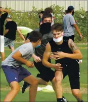  ?? PHOTO BY BRIAN SUMPTER ?? Middletown High School football players hold a recent practice complete with face masks and no football because of COVID-19 protocols. The Mustangs are just hoping they get some sort of season this year.