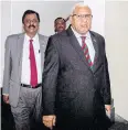  ?? AFP ?? Mr Bainimaram­a, right, Fiji’s former PM, exits parliament.