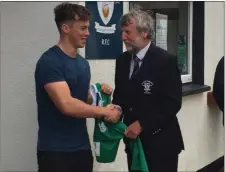  ??  ?? Jack Stafford presenting his Ireland Under-20 internatio­nal cap to Wexford Wanderers club President Herbie Honohan.