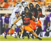  ?? BRIAN BAHR/GETTY IMAGES ?? Running back Chuba Hubbard of the Oklahoma State Cowboys breaks free from the Kansas State Cowboys recently in Stillwater, Okla. Hubbard had 296 yards in OSU’s 26-13 win.