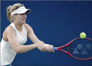  ?? The Associated Press ?? Eugenie Bouchard, of Canada, chases a shot from Harmony Tan, of France, during the first round of the U.S. Open on Tuesday in New York. Bouchard won 6-3, 6-1.