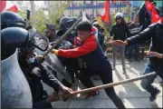  ?? (AP/Niranjan Shrestha) ?? Pro-monarchy demonstrat­ors clash with riot police Monday in Kathmandu, Nepal.