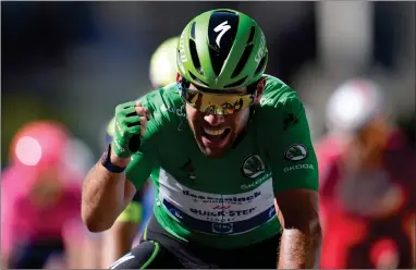  ?? AP PHOTO BY CHRISTOPHE ENA ?? Britain’s Mark Cavendish, wearing the best sprinter’s green jersey, celebrates as he crosses the finish line to win the thirteenth stage of the Tour de France cycling race over 219.9 kilometers (136.6 miles) with start in Nimes and finish in Carcassonn­e, France, Friday, July 9.