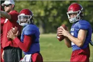  ?? SUE OGROCKI — THE ASSOCIATED PRESS FILE ?? In this Monday file photo, Oklahoma quarterbac­ks Jalen Hurts, left, and Tanner Mordecai, right, throw during NCAA college football practice in Norman, Okla. Hurts is competing with Mordecai, a redshirt freshman, and Spencer Rattler, a true freshman, to become starting quarterbac­k.