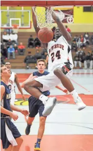  ?? MICHAEL MCLOONE / FOR THE MILWAUKEE JOURNAL SENTINEL ?? Milwaukee Riverside’s Terrence Lewis breaks away from Marquette defenders and goes in for a dunk Saturday during the Terry Porter Classic at Milwaukee South High School.