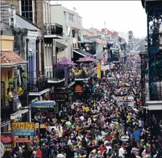  ??  ?? Bourbon Street is a sea of humanity on Mardi Gras in New Orleans in January 2020. Festivitie­s will look much different this year.