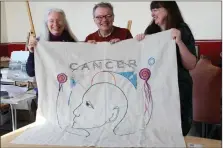  ?? ?? Artist Andrew Crummy and stitchers Heather Swinson and Gillian Hart show a panel from the cancer tapestry