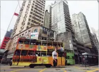  ?? SEONGJOON CHO / BLOOMBERG ?? Hong Kong’s iconic double-decker trams, nicknamed “ding dings” for the sound of their bells, remain popular with residents. The track is being revamped to reduce the noise they create.