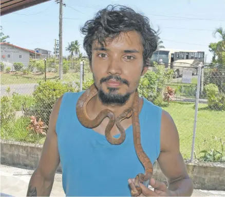  ?? Photo: Vilimoni Vaganalau ?? Alexander Feussner with his pet snake at Caubati on January 6, 2018.