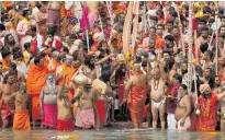  ??  ?? Hindu devotees gather to take holy dips in the Ganges River during Kumbh Mela in Uttarakhan­d, India.