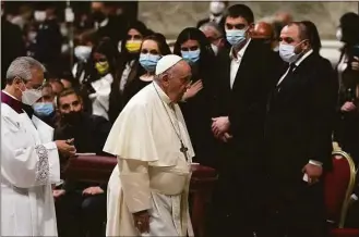  ?? Alessandra Tarantino / Associated Press ?? Pope Francis walks past Melitopol Mayor Ivan Fedorov, second from right, and Ukrainian lawmakers during a Easter vigil ceremony in St. Peter's Basilica at the Vatican on Saturday.