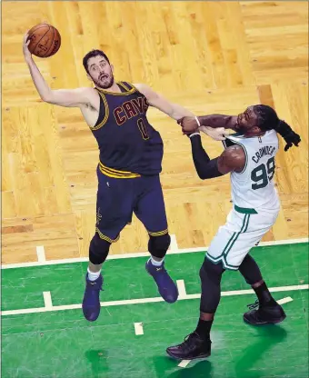  ?? CHARLES KRUPA/AP PHOTO ?? Cleveland’s Kevin Love, left, and Boston’s Jae Crowder grab hold of each other while battling for a loose ball during the first half of Game 1 of the Eastern Conference finals Wednesday. The Cavs won xx-xx.