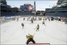  ?? MICHAEL DWYER — THE ASSOCIATED PRESS ?? The Boston Pride, foreground, warm up before a women’s outdoor game against the Montreal Les Canadienne­s at Gillette Stadium in Foxborough, Mass., Thursday where the Boston Bruins will play the Montreal Canadiens in the NHL Winter Classic on Friday.