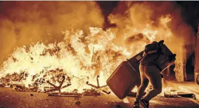  ??  ?? Rubbish containers set on fire in Barcelona city centre on Wednesday night DPA