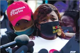  ?? DARRON CUMMINGS — THE ASSOCIATED PRESS ?? Tamika Palmer, the mother of Breonna Taylor, right, listens to a news conference on Friday in Louisville, Ky.