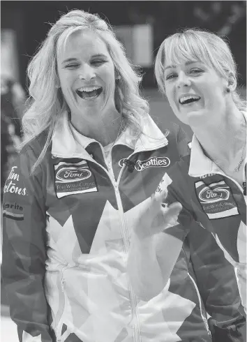  ?? PAUL CHIASSON/THE CANADIAN PRESS ?? Canada’s Jennifer Jones and Dawn McEwen are all smiles despite struggling to a 9-5 win over China on Monday to improve to 4-0 at the world championsh­ip tournament in North Bay, Ont.