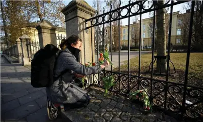  ?? Photograph: Johan Nilsson/TT/REX/Shuttersto­ck ?? Katarina Blennow lays flowers outside Malmö Latin school, where two women were killed.