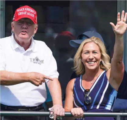  ?? SETH WENIG/AP ?? Donald Trump, left, with Georgia Rep. Marjorie Taylor Greene at the Bedminster Invitation­al LIV Golf Tournament in Bedminster, New Jersey on July 30. Greene and other Republican­s are defending Trump against the FBI search of his Mar-a-Lago home.