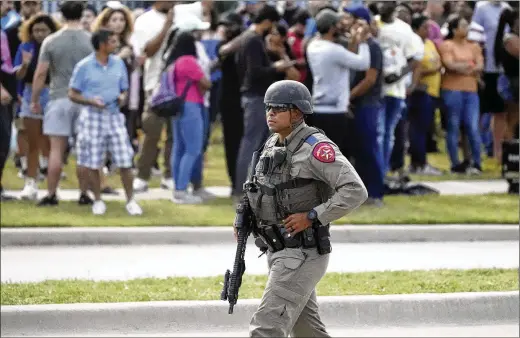  ?? LM OTERO/ASSOCIATED PRESS ?? People are evacuated from a shopping center after a mass shooting May 6 in Allen, Texas. Eight were killed. Guns have long been a part of Texas culture, but to equate the number of guns with the number of people killed by guns strikes some as a false equivalenc­e.