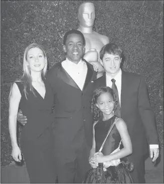  ?? Krista Kennell/afp/getty Images/files ?? Dwight Henry, middle, Quvenzhane Wallis, foreground, and crew of Beasts of the Southern Wild at 2012 Governors Awards at the Hollywood & Highland Center on Dec. 1. The film yielded no Globe nomination­s.