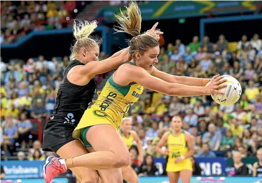  ?? GETTY IMAGES ?? New Zealand midcourt star Laura Langman tussles with Liz Watson during the Constellat­ion Cup match in Brisbane yesterday, won convincing­ly by Australia.