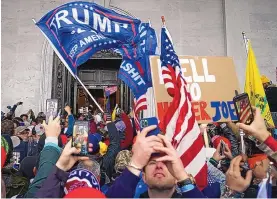  ?? JOHN MINCHILLO/ASSOCIATED PRESS ?? A crowd of then-President Donald Trump’s supporters riots outside the Capitol on Jan. 6. Many who have been charged in the riot are representi­ng themselves.