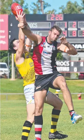  ?? ?? Districts’ Patrick Gallow fails to stop his Nightcliff rival from taking the mark at Norbuilt Oval on Saturday as (below) Croc Leigh Williams hits the deck in a battle for possession. Pictures: Julianne Osborne