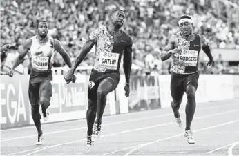  ?? FABRICE COFFRINI/GETTY-AFP ?? At 37 years old, Justin Gatlin, center, often trains with younger athletes and schedules rest days to keep himself fresh.