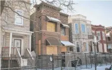  ??  ?? A two- flat in the 4000 block of West Wilcox is boarded up after a man and woman, both 90, died in a fire Tuesday.
| ASHLEE REZIN/ SUN- TIMES