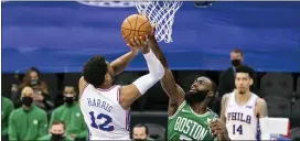  ?? CHRIS SZAGOLA — THE ASSOCIATED PRESS ?? Boston’s Jaylen Brown, right, blocks a shot by the Sixers’ Tobias Harris during the first half on Wednesday.