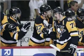  ?? KEITH SRAKOCIC — THE ASSOCIATED PRESS ?? Pittsburgh Penguins’ Carter Rowney (37) celebrates with Evgeni Malkin (71) after he scored against the Nashville Predators during Game 1 of the Stanley Cup Finals, Monday in Pittsburgh.