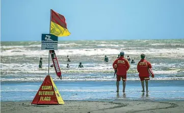  ?? MURRAY WILSON/STUFF ?? Surf lifeguards watch over Foxton Beach as swimmers take to the sea.