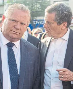  ?? CHRIS YOUNG/THE CANADIAN PRESS ?? Premier Doug Ford and Mayor John Tory joined a candlelit vigil to honour the victims of a deadly shooting in Toronto on July 25. Ford’s plan to slash Toronto city council in half came as a surprise and “the people who are saying ‘Let’s talk about this’...