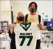  ?? Jeff Jacobs / Hearst Connecticu­t Media / ?? Maloney's Daejon Nixon, right, poses with Yvonne Royce as part of the football team's jersey swap to honor the school's teachers.