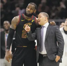  ?? Tony Dejak / Associated Press ?? LeBron James, chatting with Cavaliers coach Tyronn Lue, is not expected to decide on his future until after the draft.