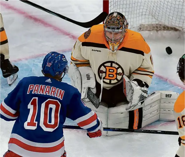  ?? JOHN TLUMACKI/GLOBE STAFF ?? The Rangers’ Artemi Panarin beat Bruins goalie Jeremy Swayman twice in the second period and finished a hat trick into an empty net.