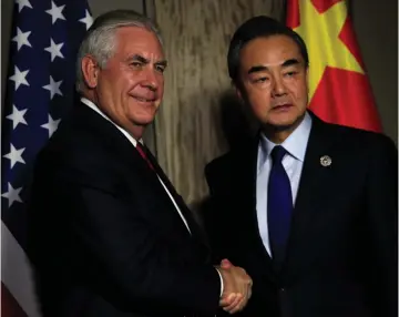  ?? (Romeo Ranoco/Reuters) ?? US SECRETARY OF STATE Rex Tillerson shakes hands with People’s Republic of China Foreign Minister Wang Yi, before their bilateral talks in Manila, Philippine­s on Saturday.