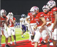  ?? Erik Verduzco Las Vegas Review-journal ?? Liberty’s Colin Gregorio (4) is joined by teammates after scoring a touchdown against Kamehameha Kapalama (Hawaii) at Liberty High on Friday night. The Patriots won 25-18.