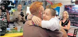  ?? CARLINE JEAN/SUN SENTINEL ?? Activist and Parkland shooting survivor, Emma González and Manuel Oliver, the father of slain Parkland school student Joaquin “Guac” Oliver, hug during an election watch party.