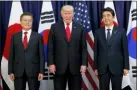  ?? EVAN VUCCI — THE ASSOCIATED PRESS FILE ?? In this file photo, U.S. President Donald Trump, center, meets with Japanese Prime Minister Shinzo Abe, right, and South Korean President Moon Jae-in before the Northeast Asia Security dinner at the U.S. Consulate General Hamburg in Germany.